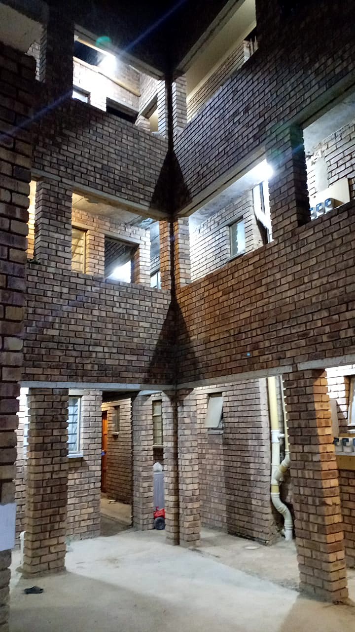 Kenla Village — three-storey face-brick block around a courtyard